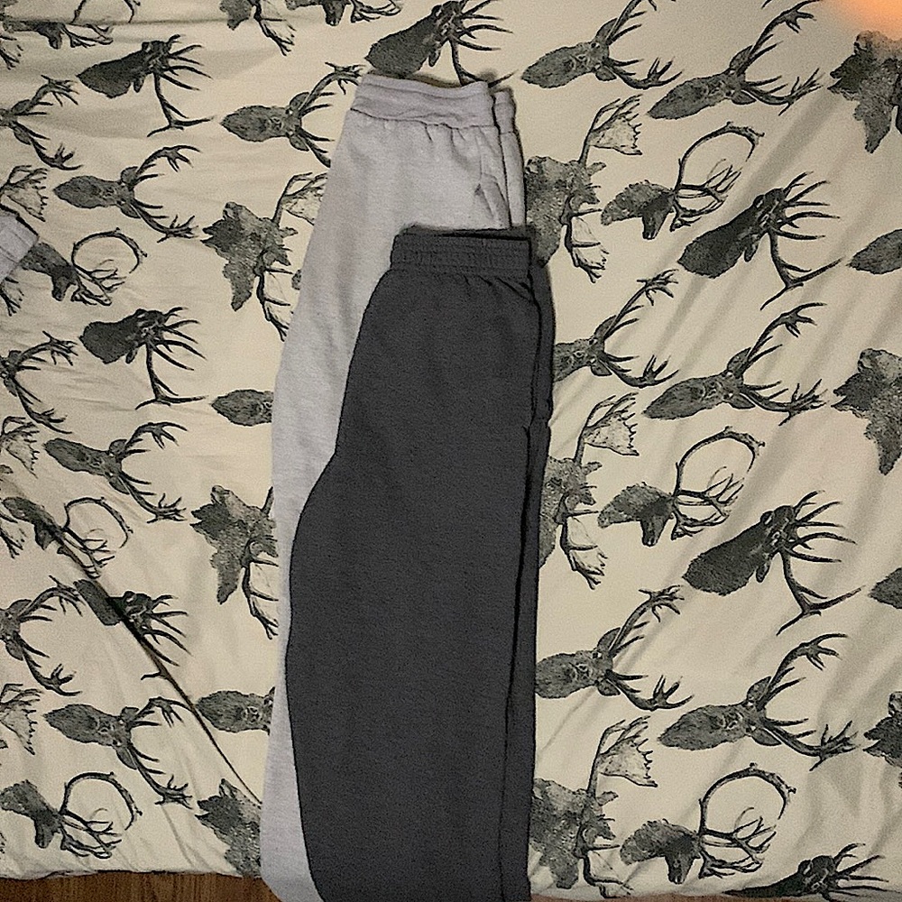 two black and grey sweatpants